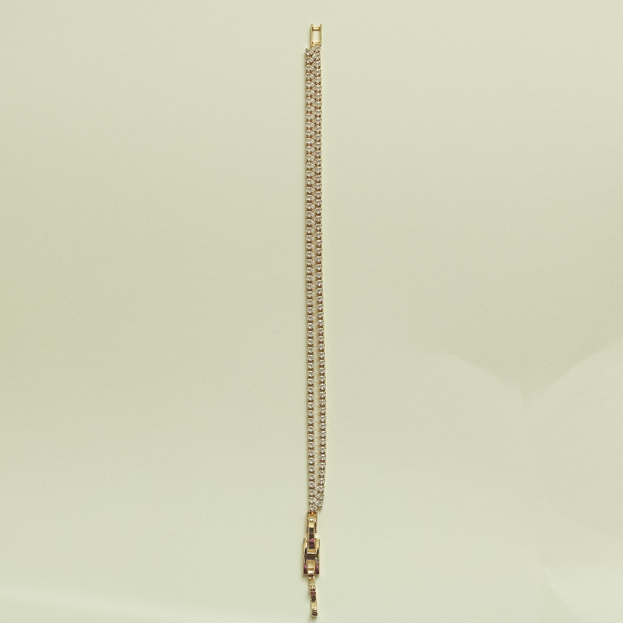 Gold-tone tennis bracelet with clear CZ pavé, extended view with box clasp.