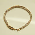 Gold-tone double-row tennis bracelet with clear CZ stones and box clasp, front view.
