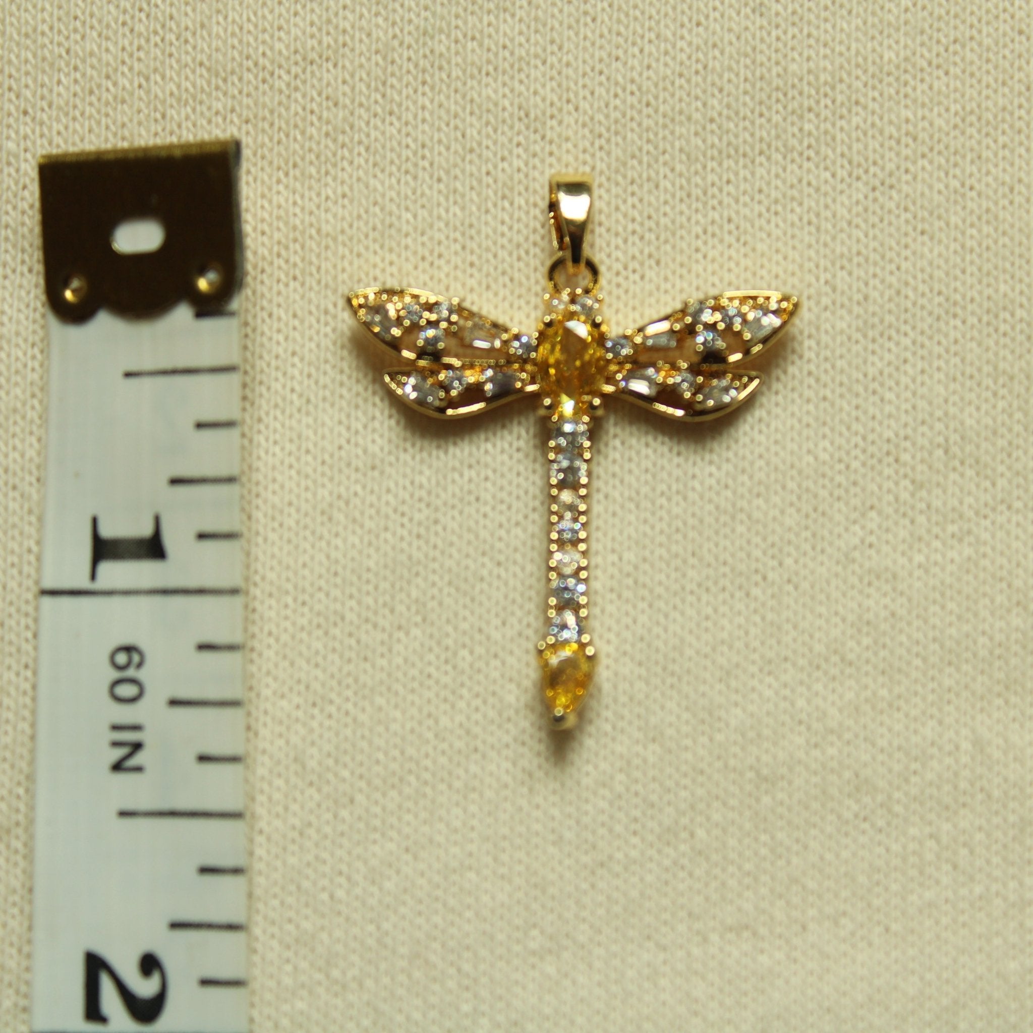 Gold dragonfly pendant with dangling drop and sparkling pavé stones