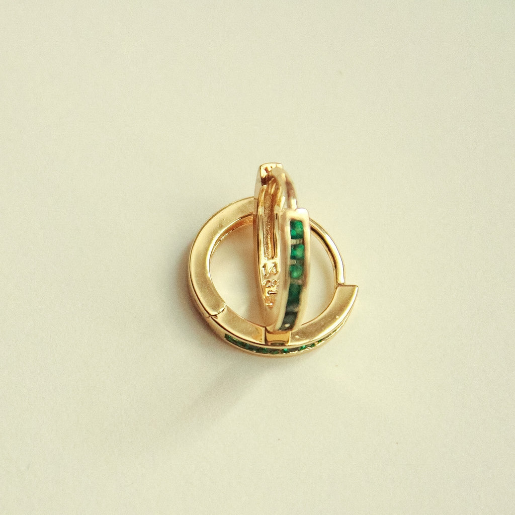 Gold-tone mini huggie hoop earrings, front view with green CZ bar center