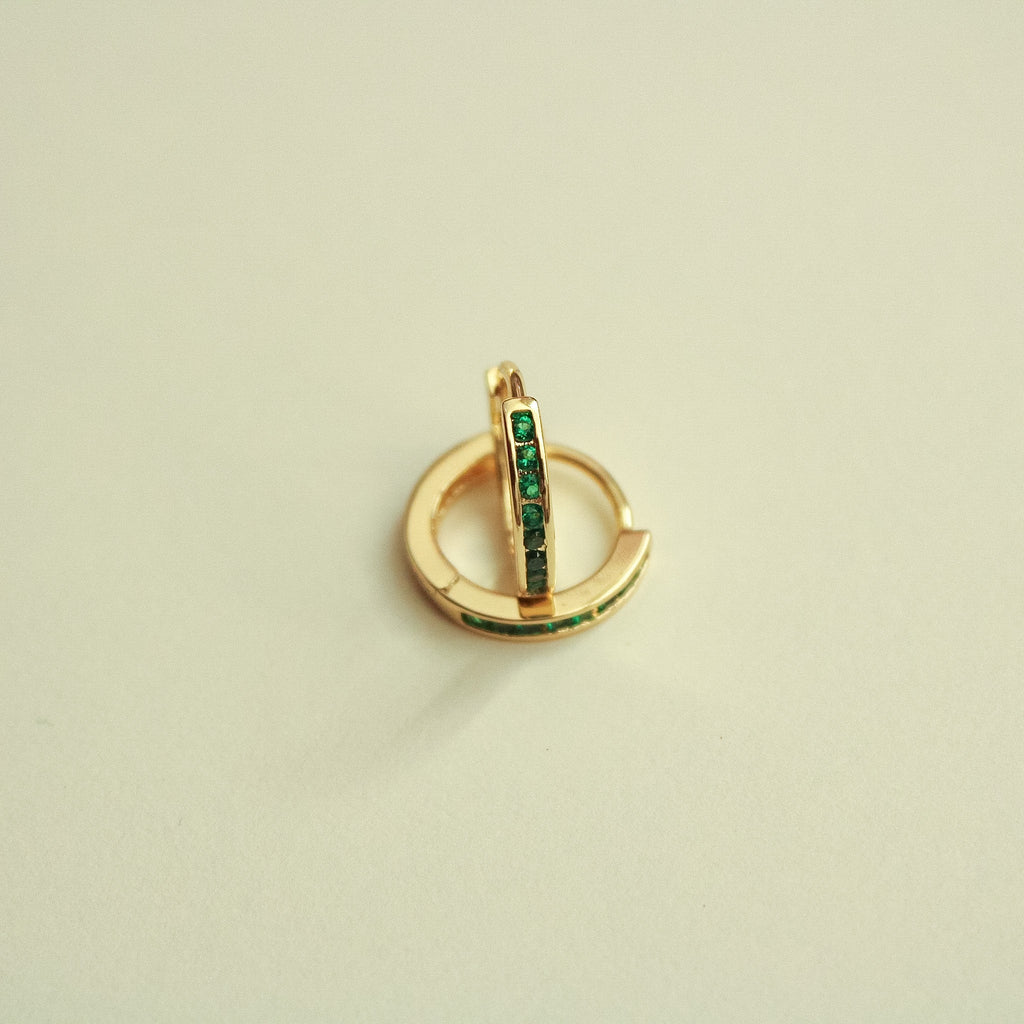 Gold-tone mini huggie hoop earrings with green CZ vertical stone strip