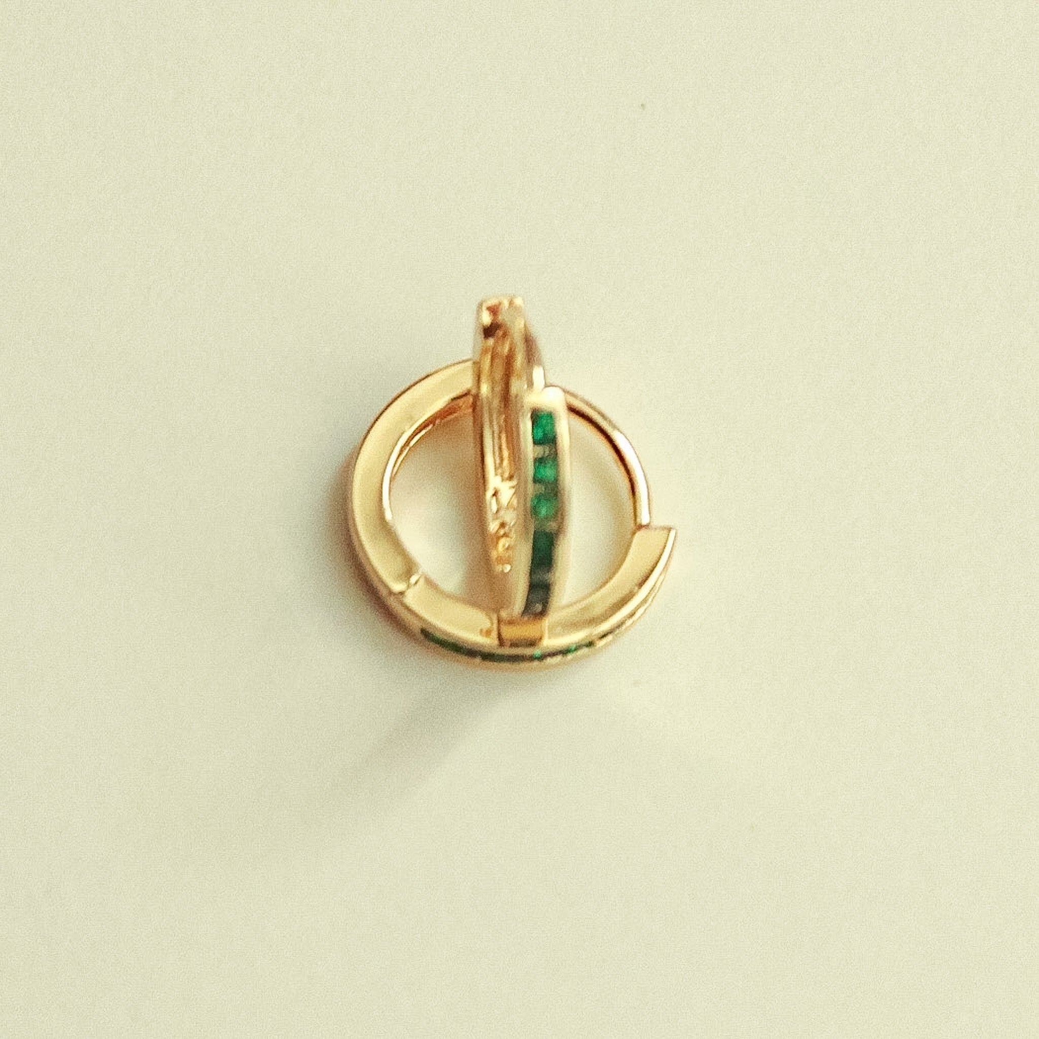 Gold-tone mini huggie hoop earrings with green CZ vertical bar detail