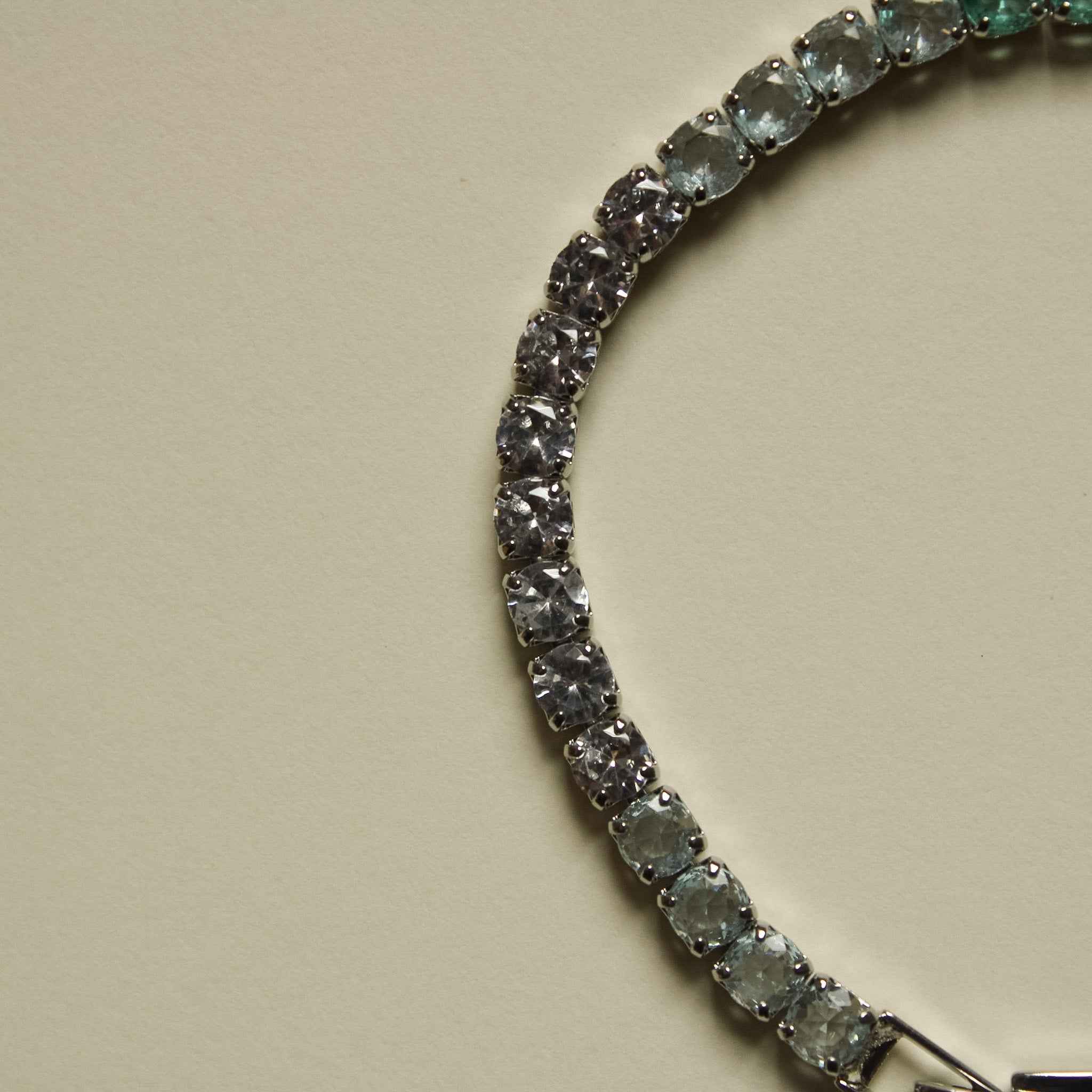 Tennis bracelet with clear stones and metal clasp end