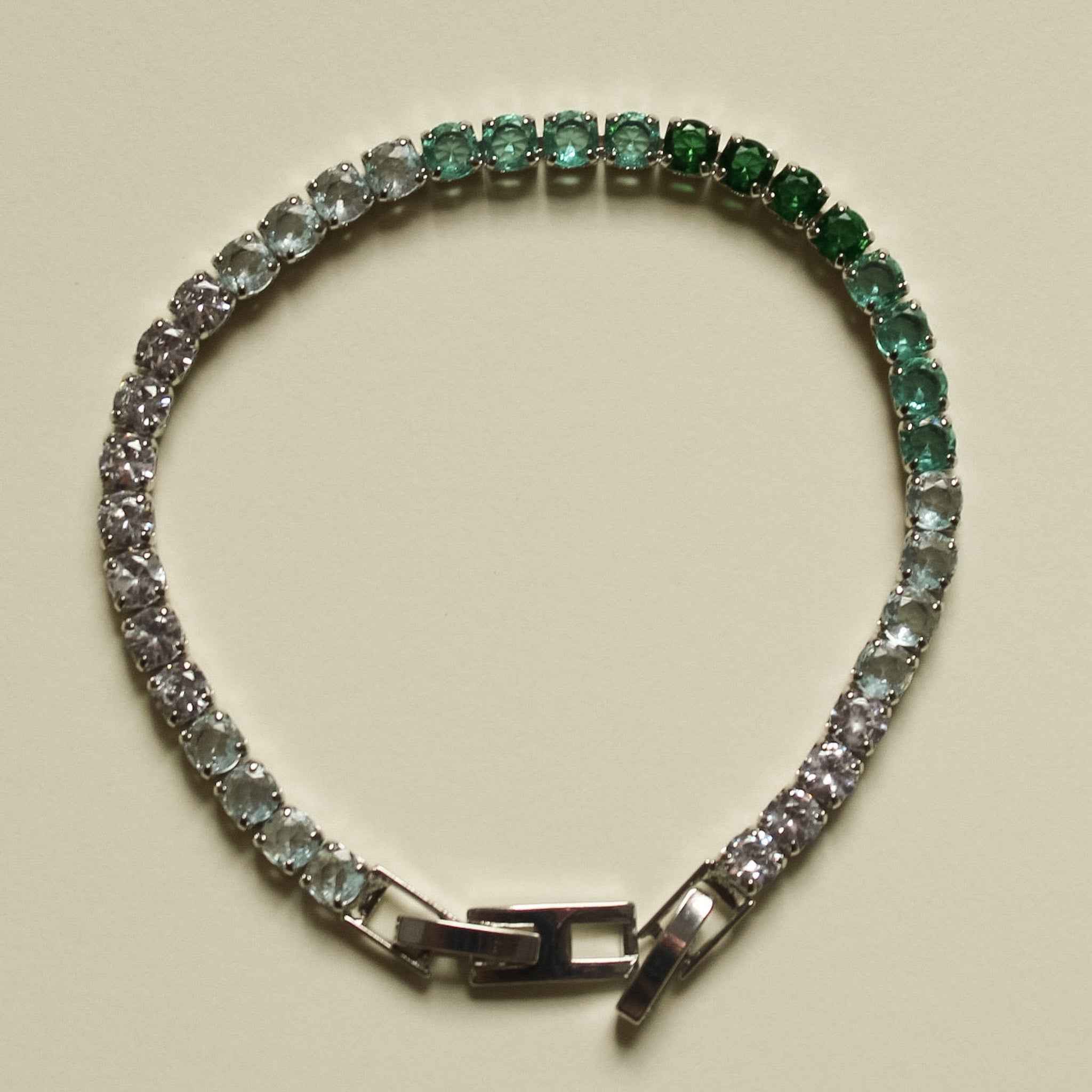 Ombre tennis bracelet, half green and half clear stones, with box clasp