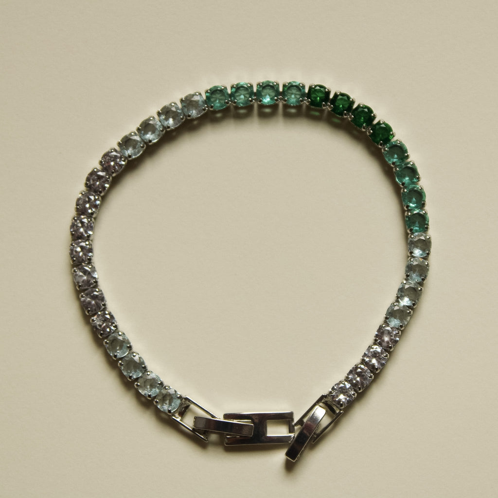 Ombre tennis bracelet with alternating green to clear stones and box clasp