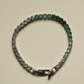 Ombre tennis bracelet with alternating green to clear stones and box clasp