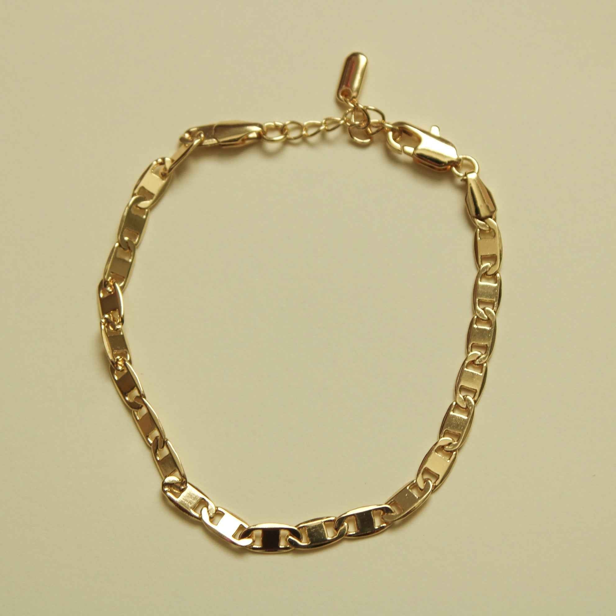 Gold-tone anchor link bracelet with clasp and polished chain links.