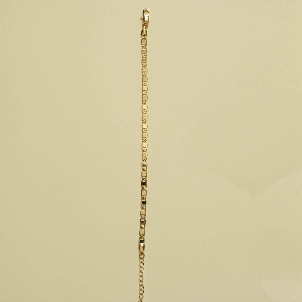 Gold-tone anchor link bracelet hanging straight with small chain links.