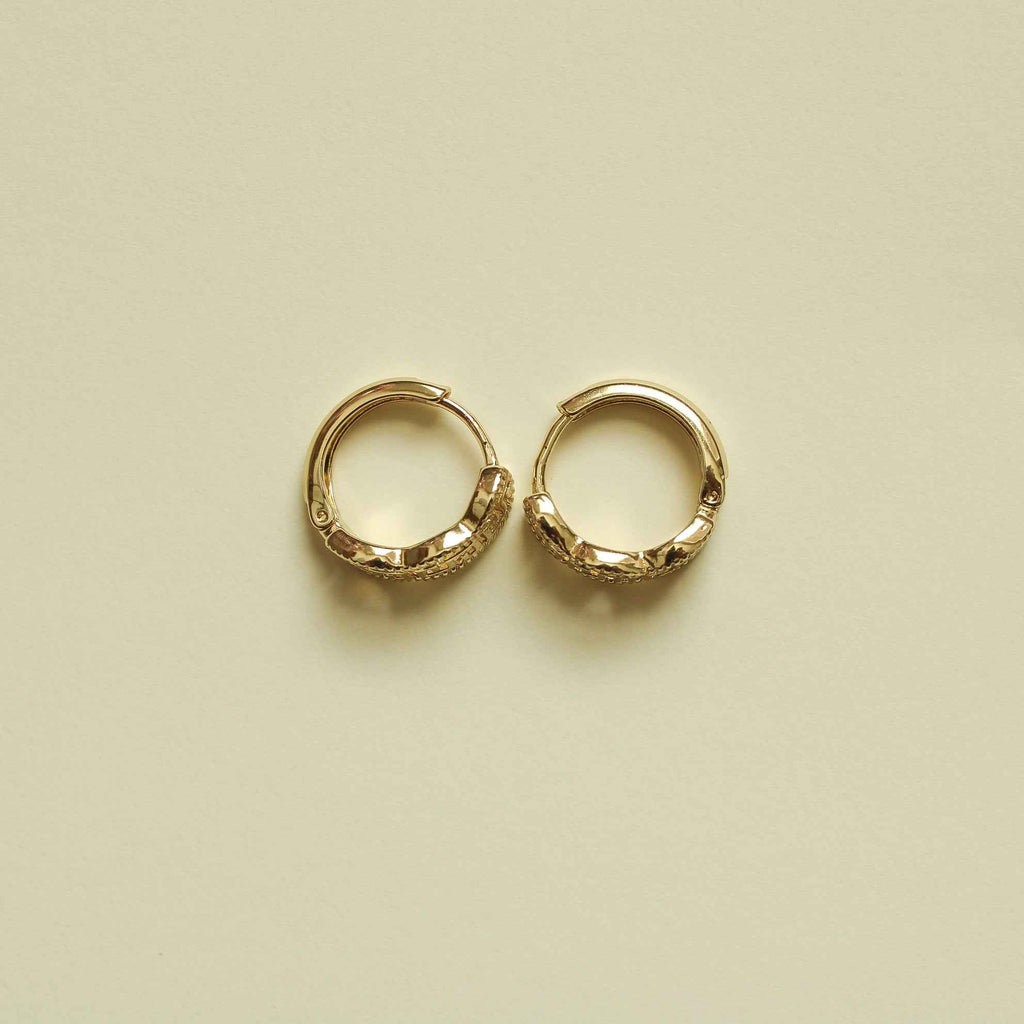 Gold Greek key huggie hoop earrings, pair shown from front