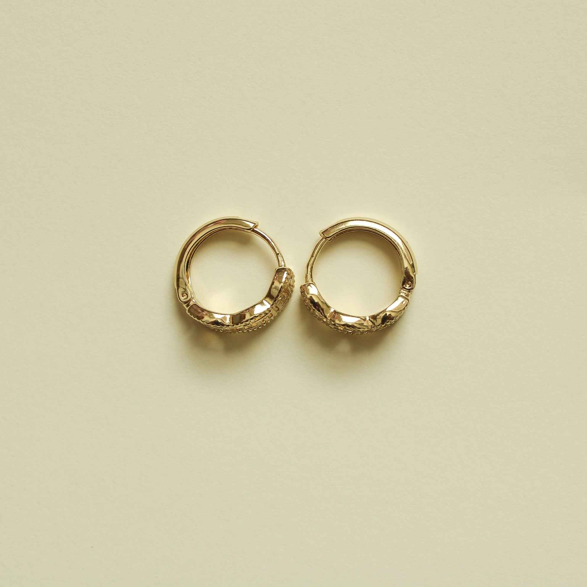 Gold Greek key huggie hoop earrings, pair shown from front