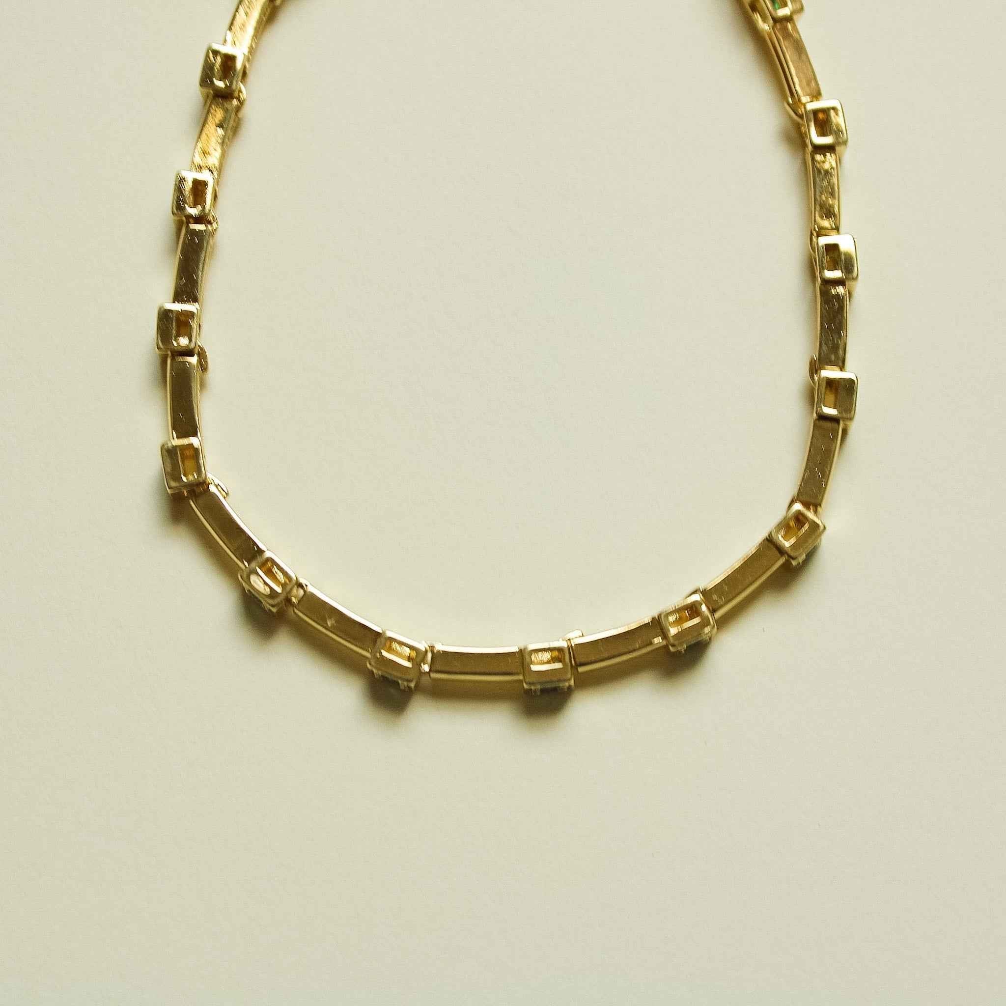 Gold-tone bar link bracelet, side view showing rectangular settings