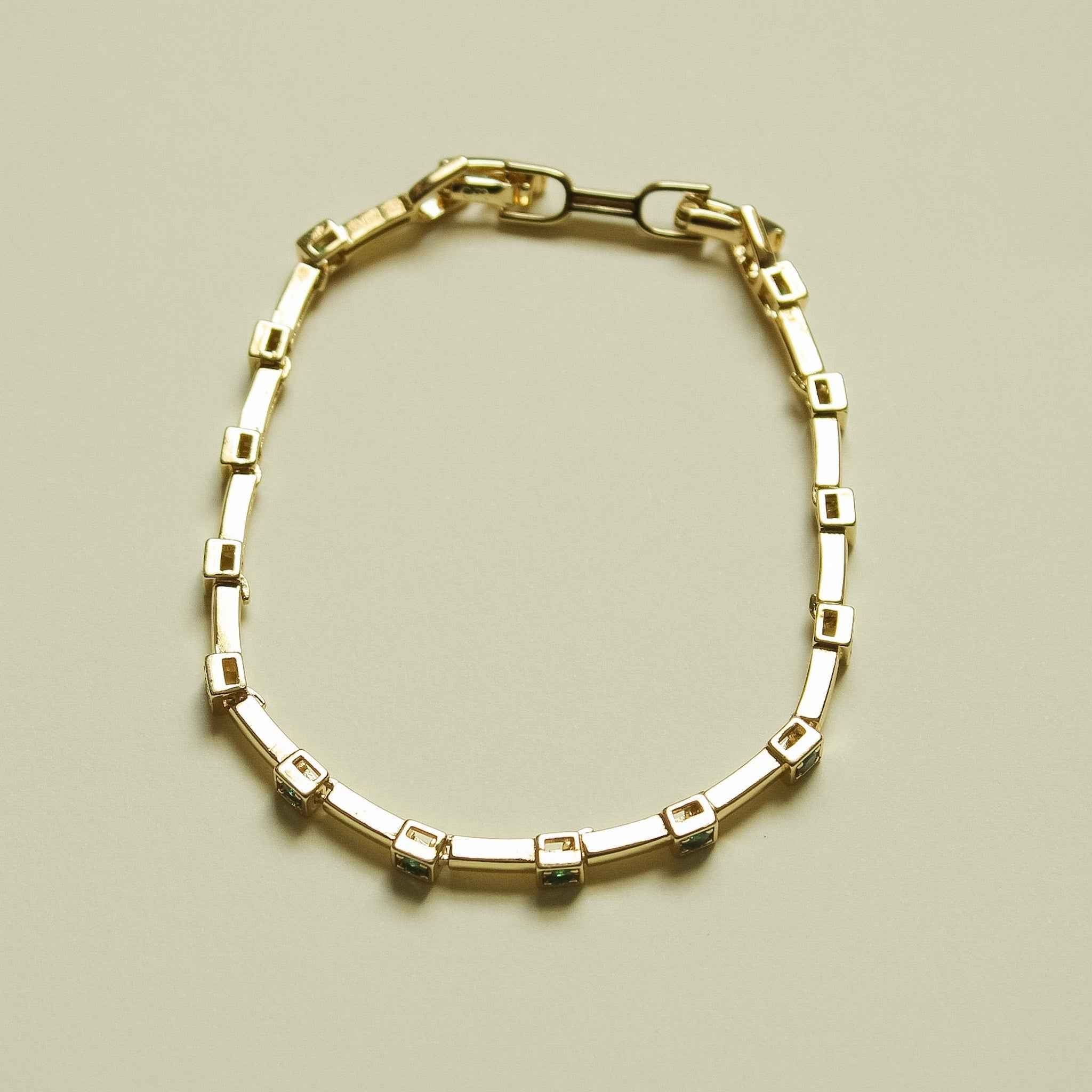 Gold-tone bar link bracelet with square-link bezel detailing, round fit