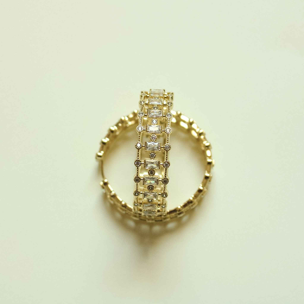 Gold inside-out hoop earring with mixed cut CZ stones