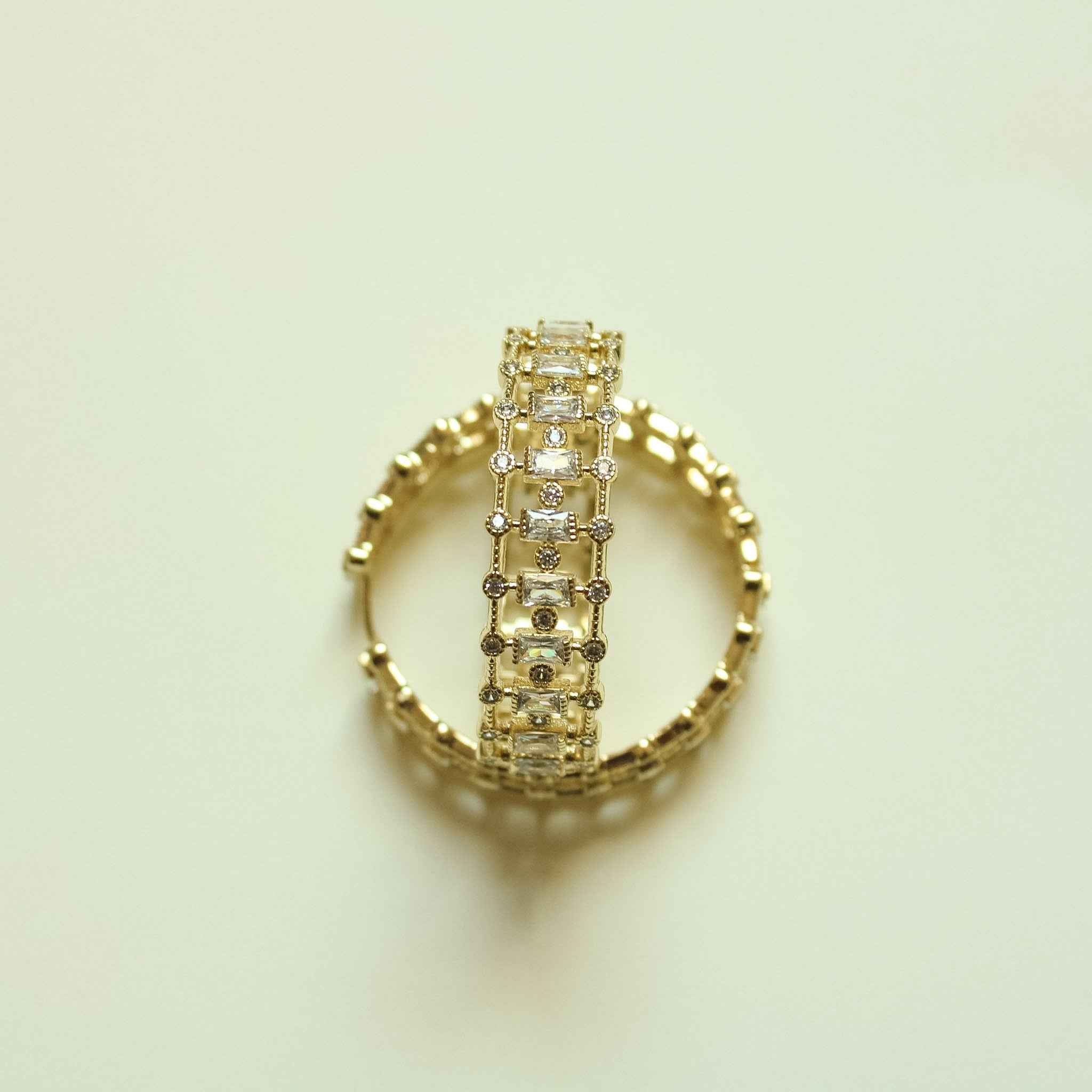 Gold inside-out hoop earring with mixed cut CZ stones