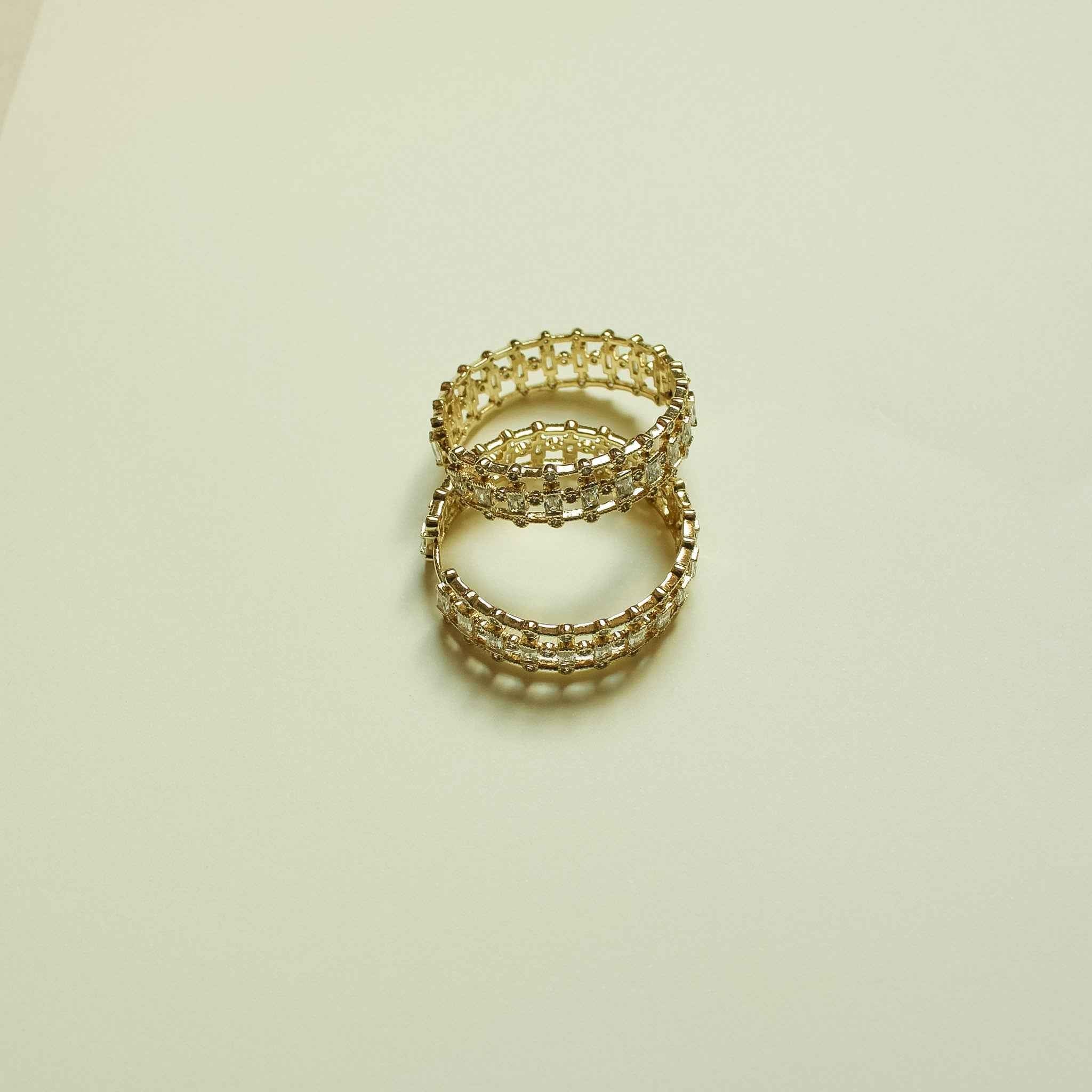 Gold hoop earrings with mixed-cut CZ stones, shown stacked together