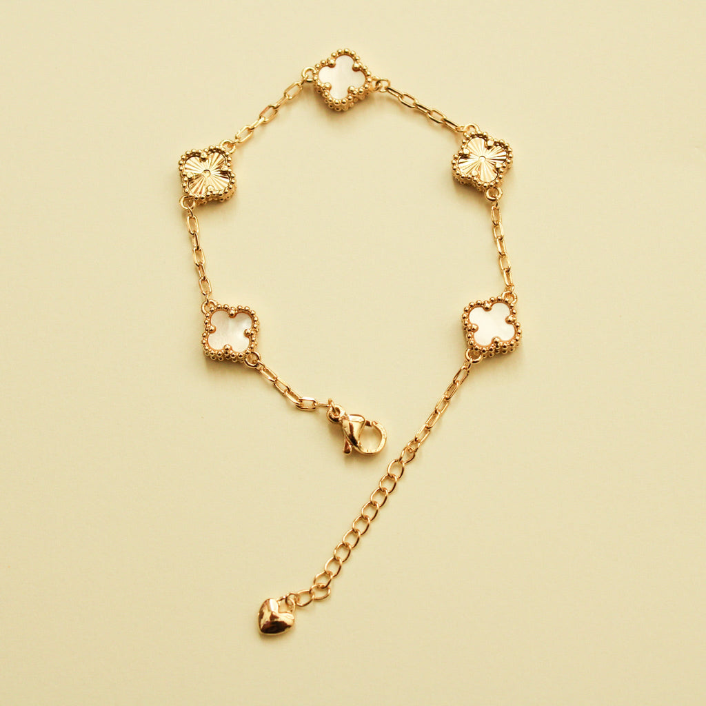 Gold clover bracelet with mother-of-pearl inlays and heart drop charm
