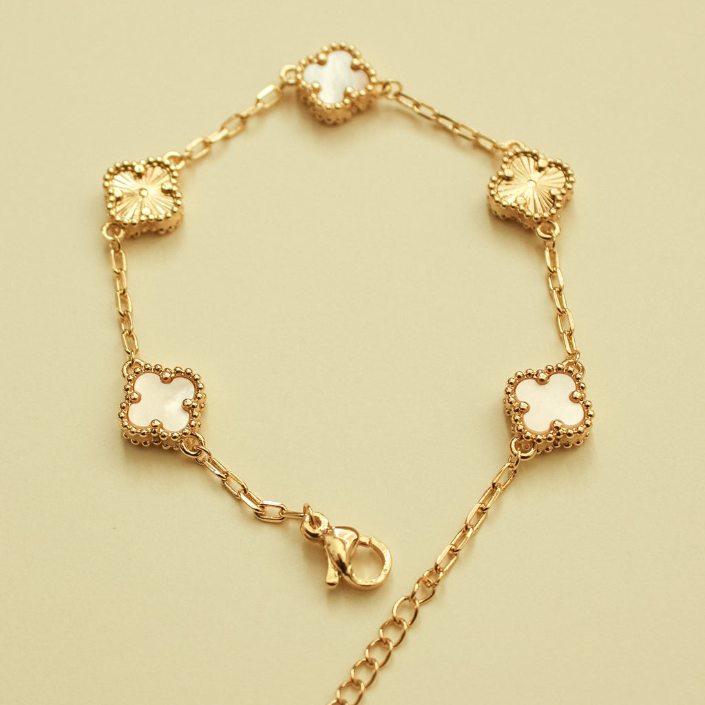 Gold-tone bracelet with mother-of-pearl clover charms and chain links