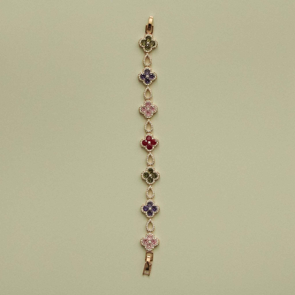 Gold-tone clover CZ bracelet with multicolor flower stations on a vertical chain