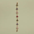 Gold-tone clover CZ bracelet with multicolor flower stations on a vertical chain