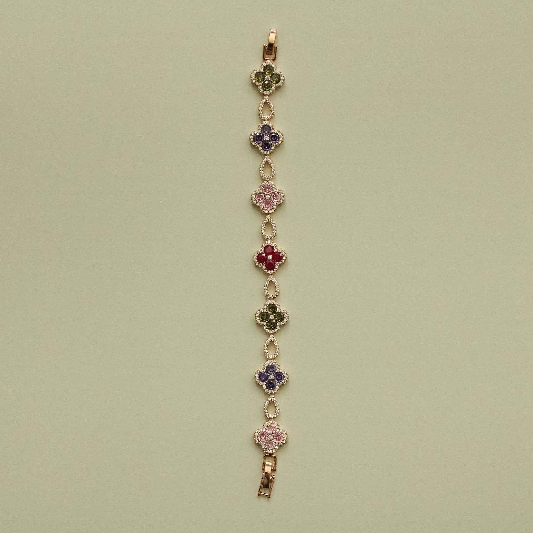 Gold-tone clover CZ bracelet with multicolor flower stations on a vertical chain