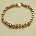 Gold tennis bracelet with multicolor CZ round stones in bezel settings, link chain