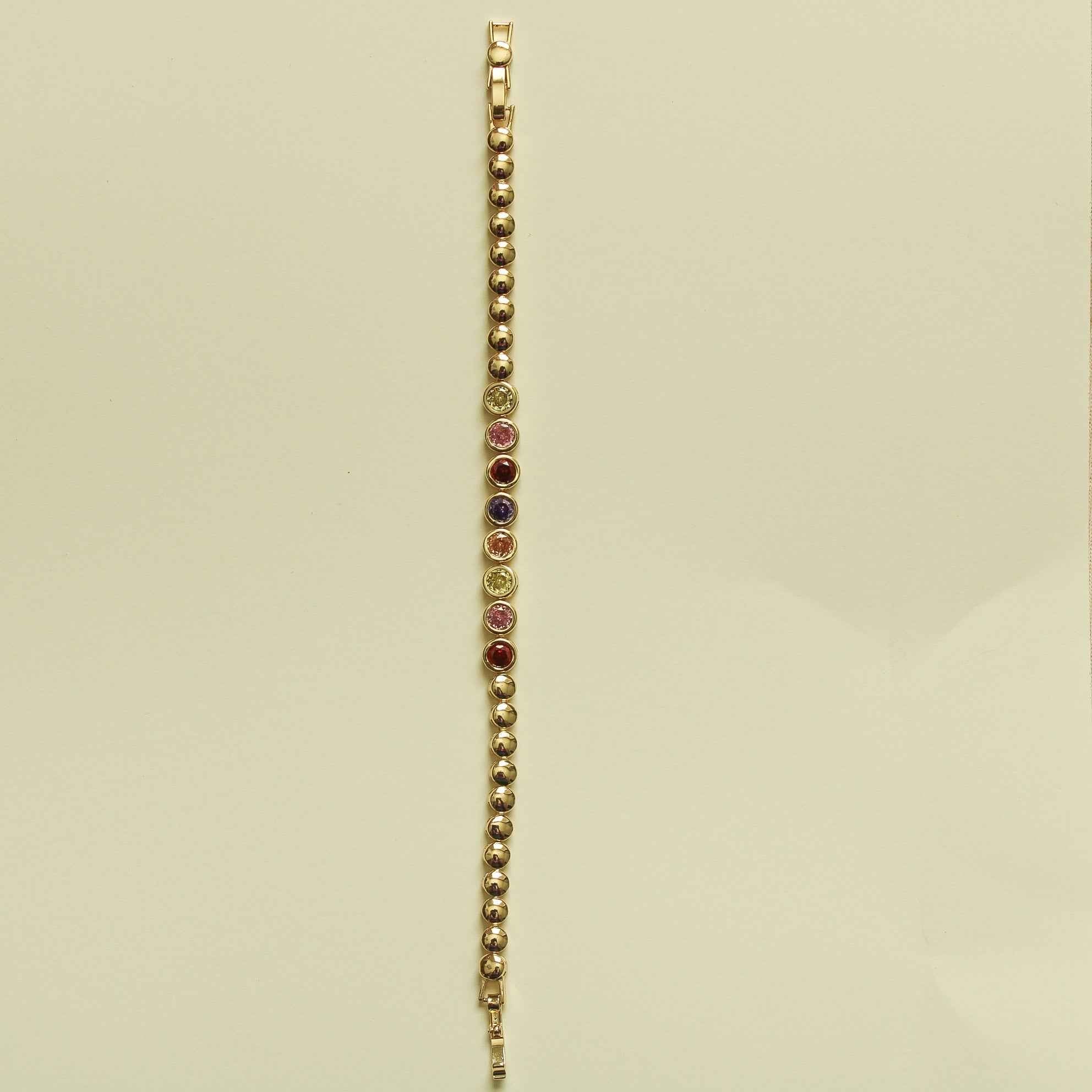 Gold tennis bracelet with slim row of multicolor CZ bezel stones