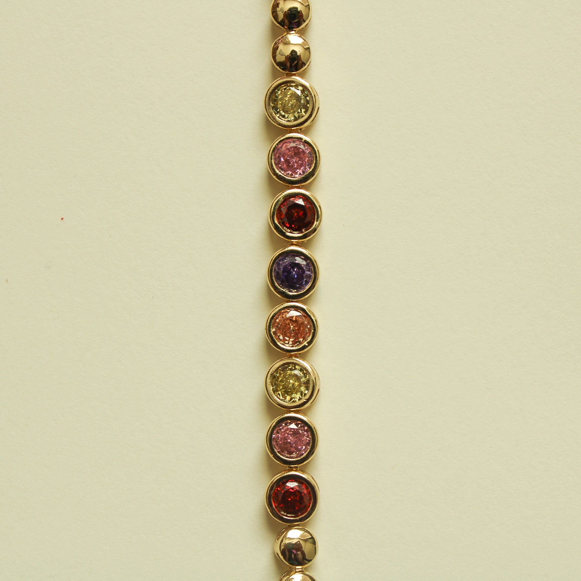 Gold tennis bracelet with round multicolor CZ bezel stones