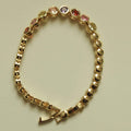 Gold beaded tennis bracelet with multicolor CZ bezel stones and toggle clasp