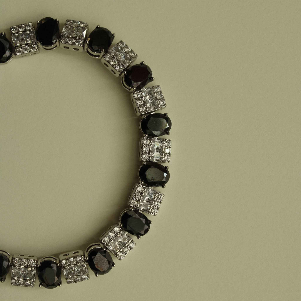 Silver tennis bracelet with black oval stones and clear square CZ links