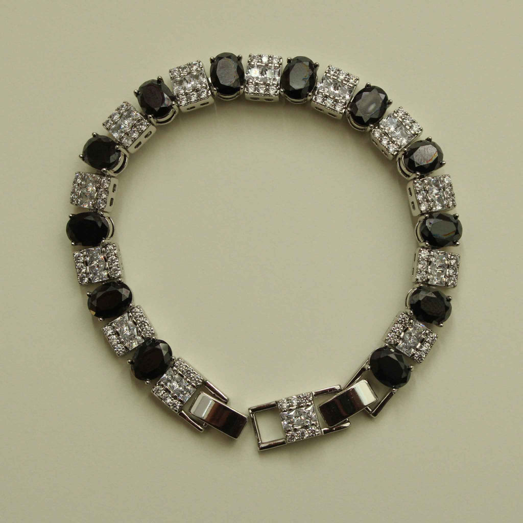 Tennis bracelet front view with black oval stones and clear square CZ links