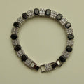 Tennis bracelet front view with black oval stones and clear square CZ links