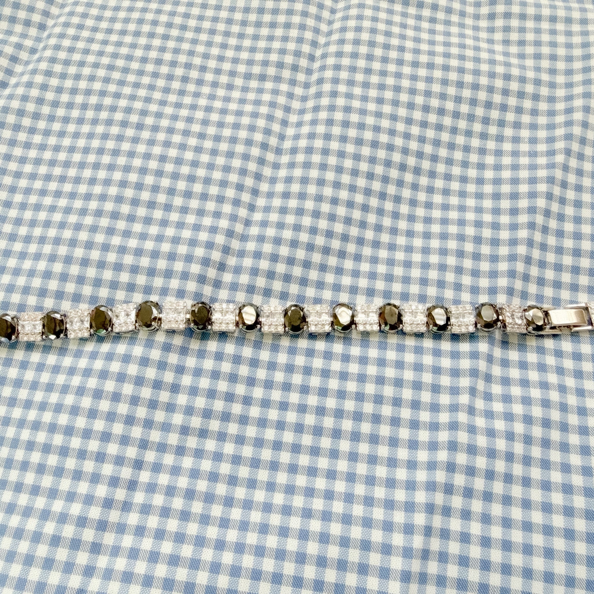 Tennis bracelet side view with black stones and clear square CZ rows