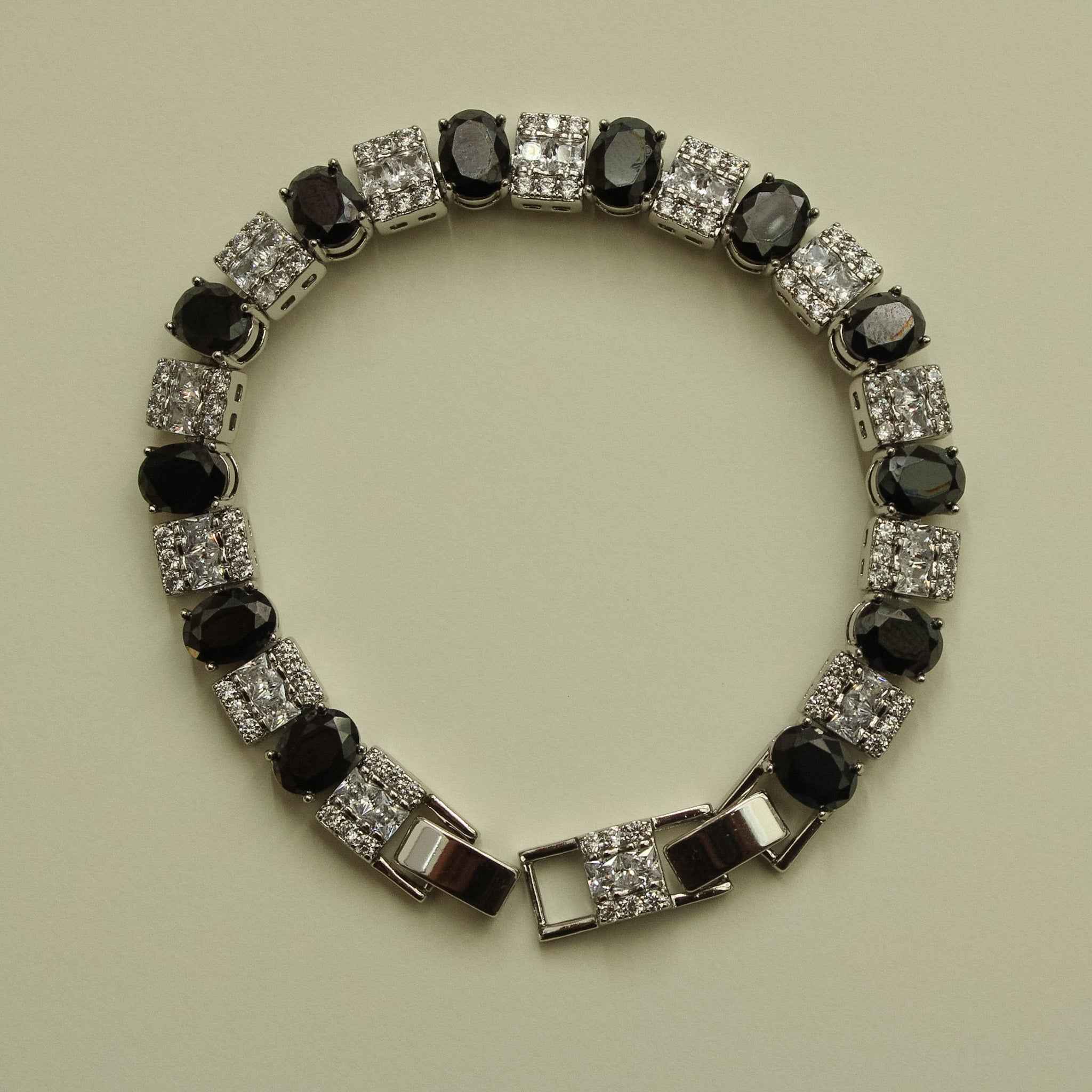 Silver tennis bracelet with black round stones and clear square CZ accents