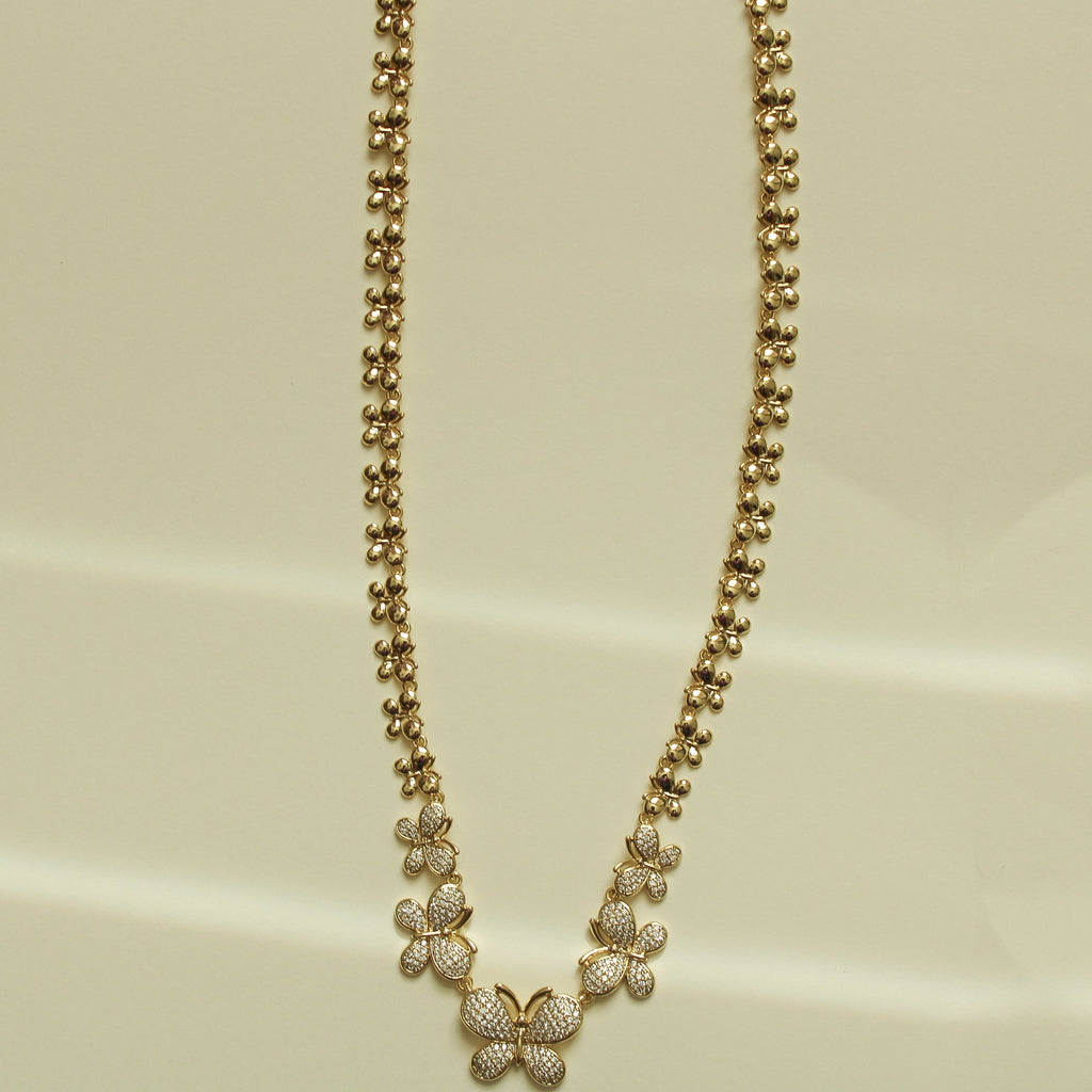 Gold butterfly necklace with small pavé butterfly charms along ball-bead chain