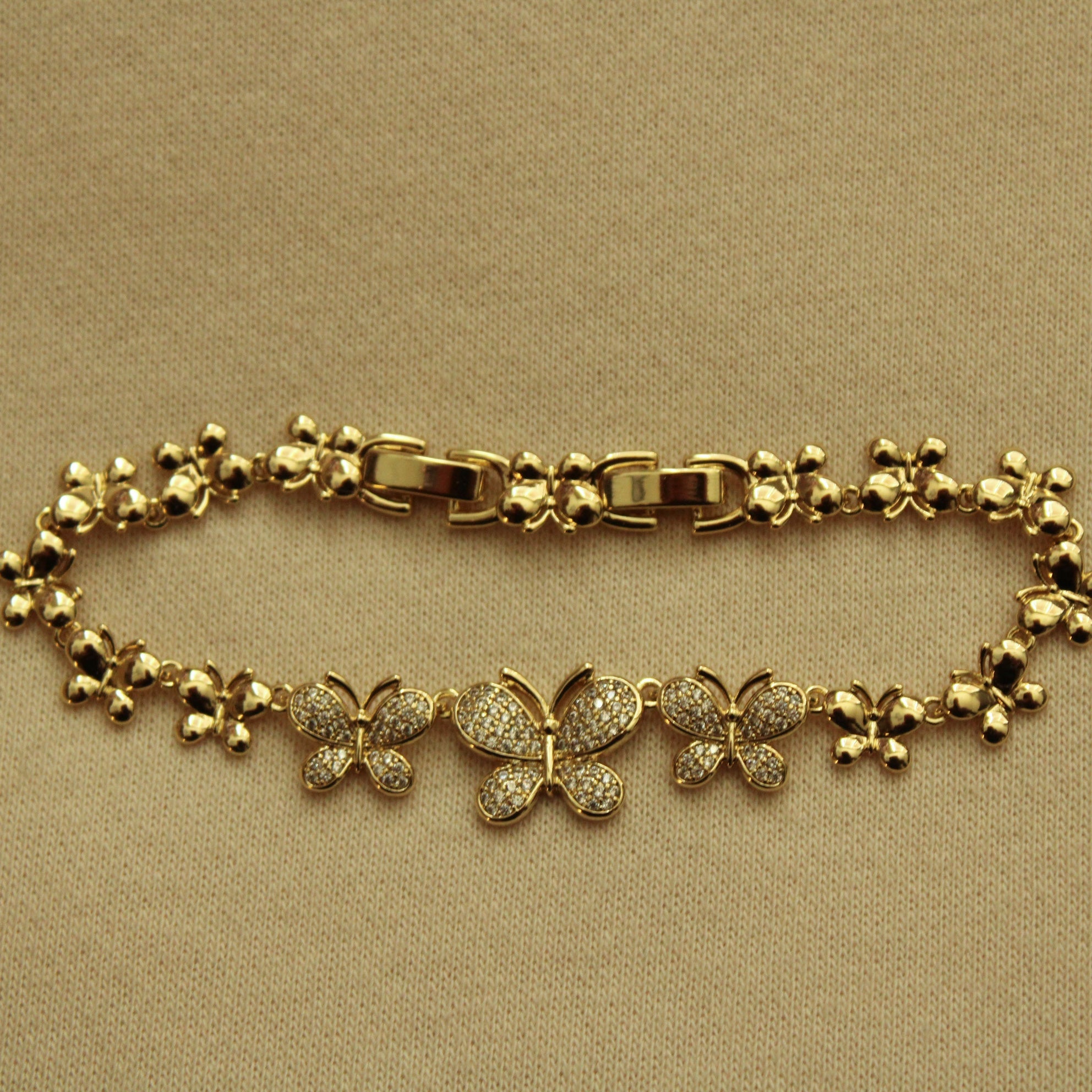 Gold butterfly bracelet with toggle clasp and pavé bead-and-chain links