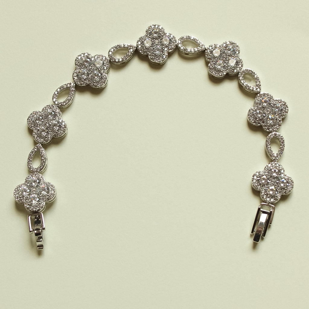 Silver-tone CZ clover bracelet with round clover charms, oval links, and spring clasp