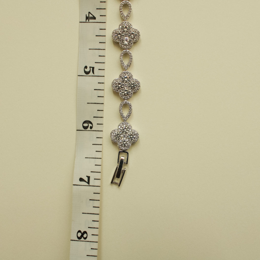 CZ clover flower bracelet measured on ruler, showing oval links and clasp