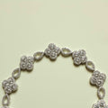 CZ clover flower bracelet with silver-tone links and oval spacer stones
