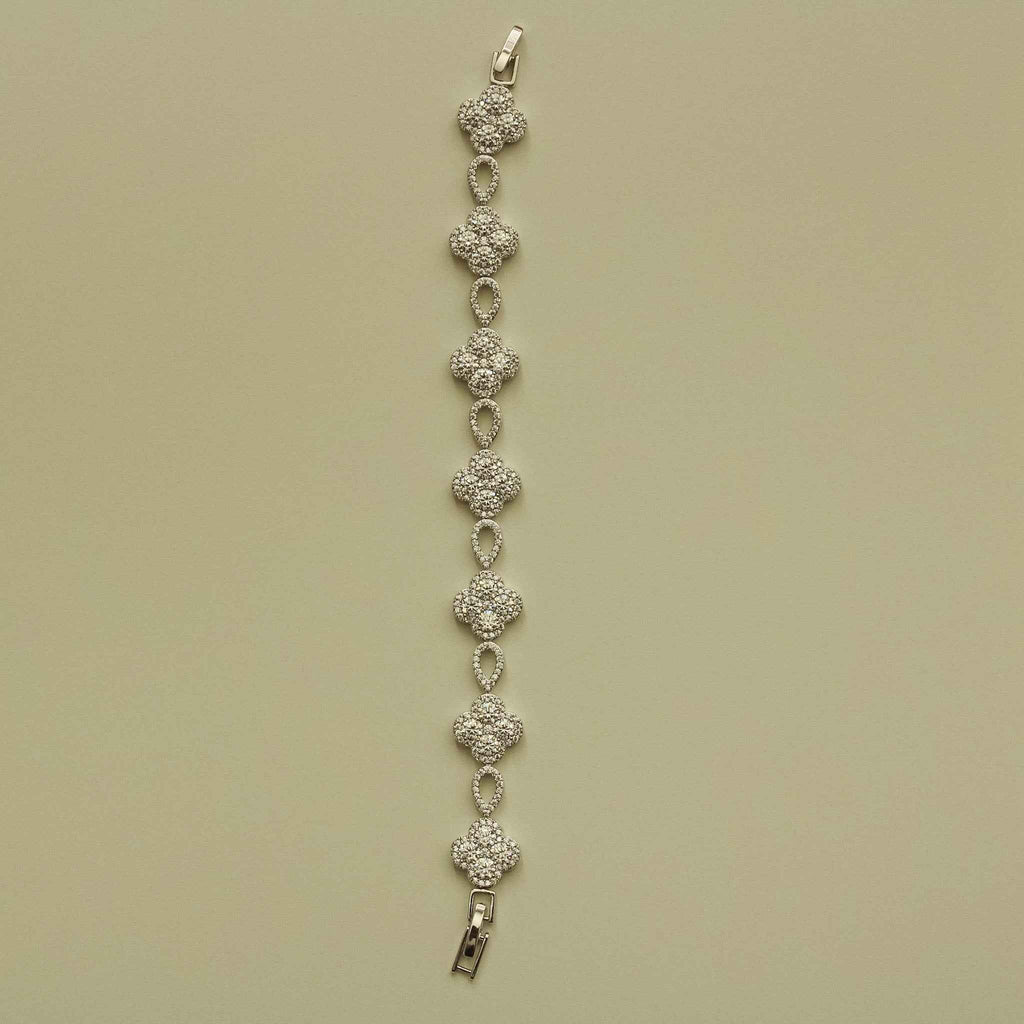 Silver-tone CZ clover bracelet strand with teardrop links and metal clasp end