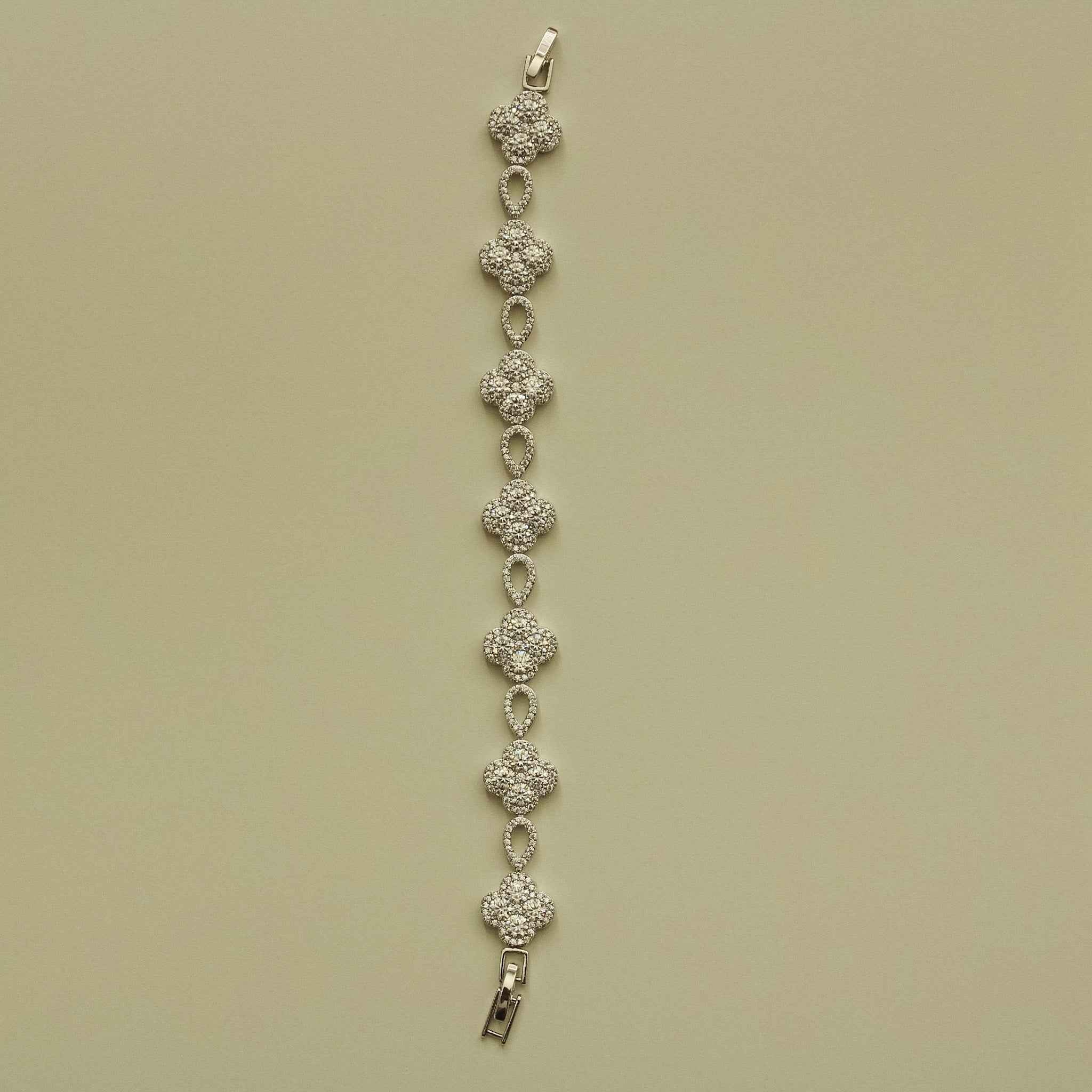 Silver-tone CZ clover bracelet strand with teardrop links and metal clasp end