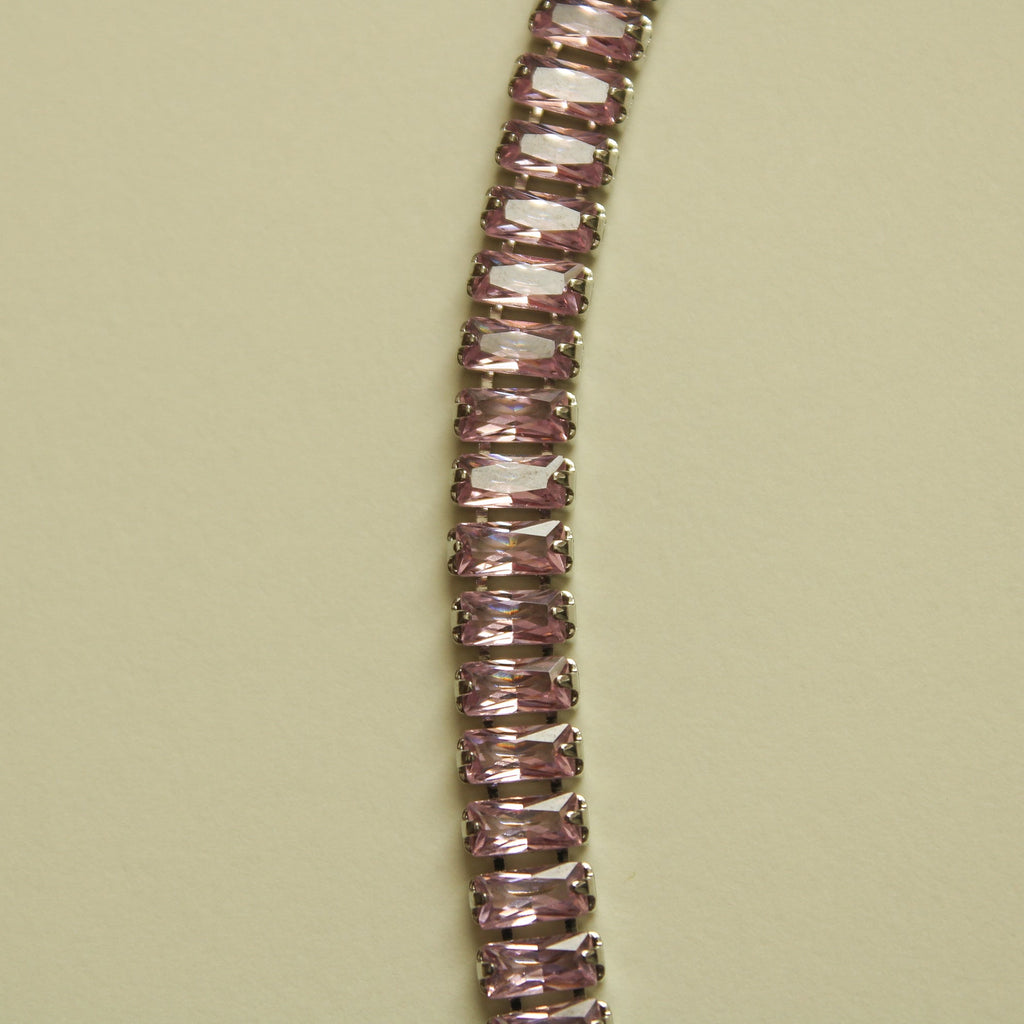 Pink baguette tennis necklace with faceted stones, close-up