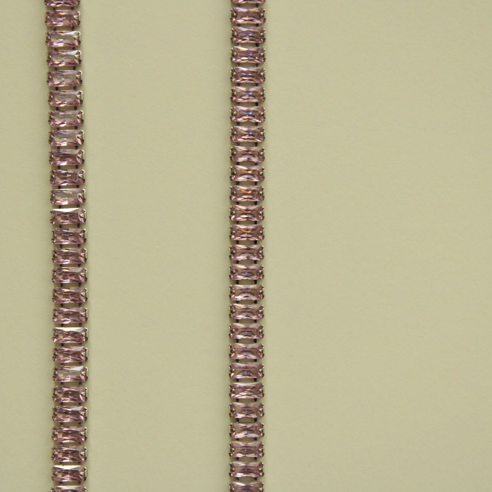 Pink baguette tennis necklace, vertical close-up of faceted stone links