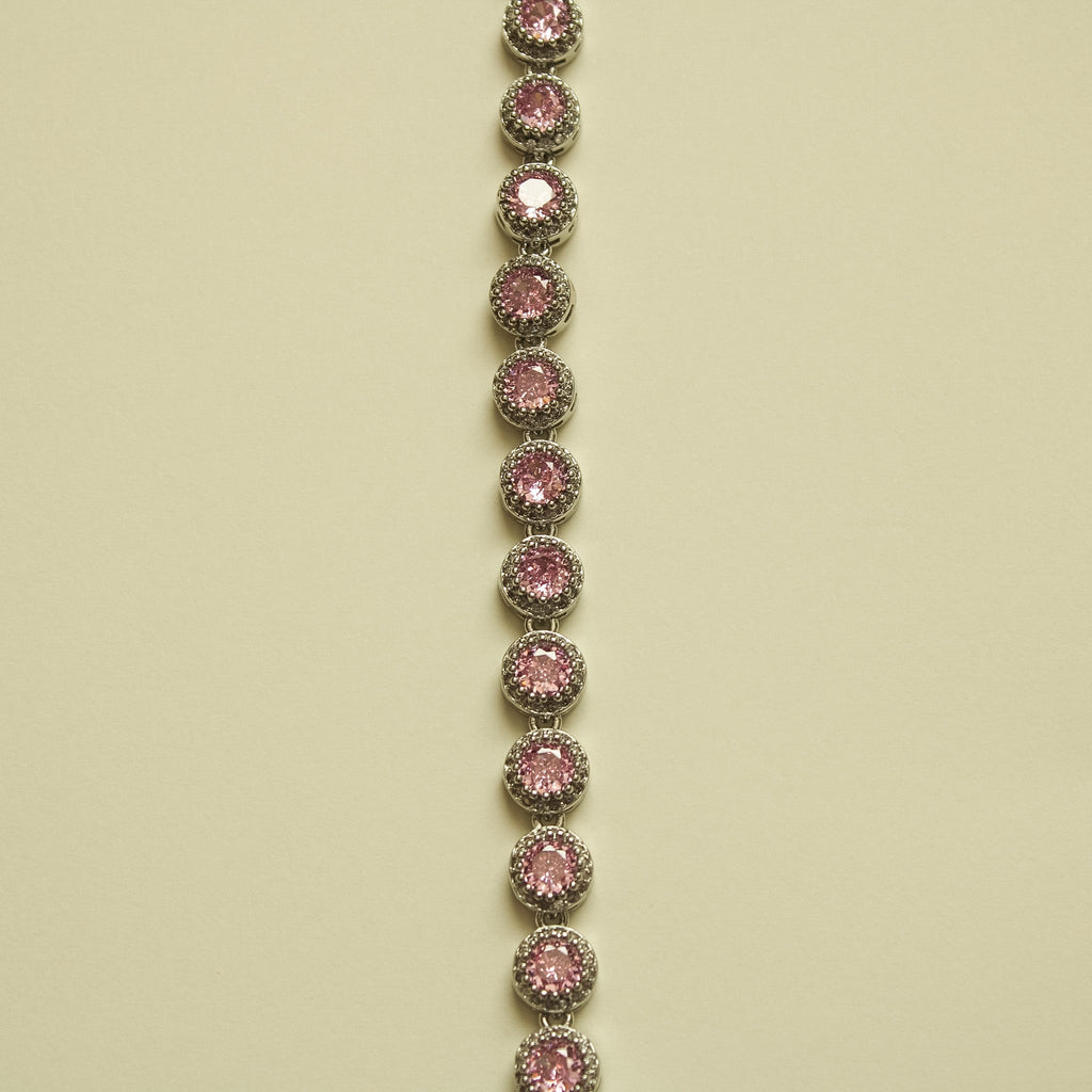 Pink halo CZ tennis bracelet, vertical view of linked round bezel-set stones