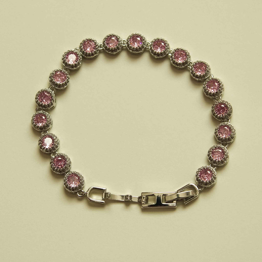 Pink halo CZ tennis bracelet with round stones and silver-tone box clasp