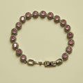 Pink halo CZ tennis bracelet with round stones and silver-tone box clasp
