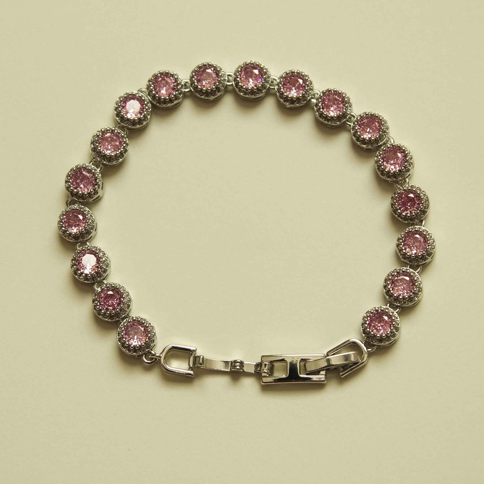 Pink halo CZ tennis bracelet with round stones and silver-tone box clasp