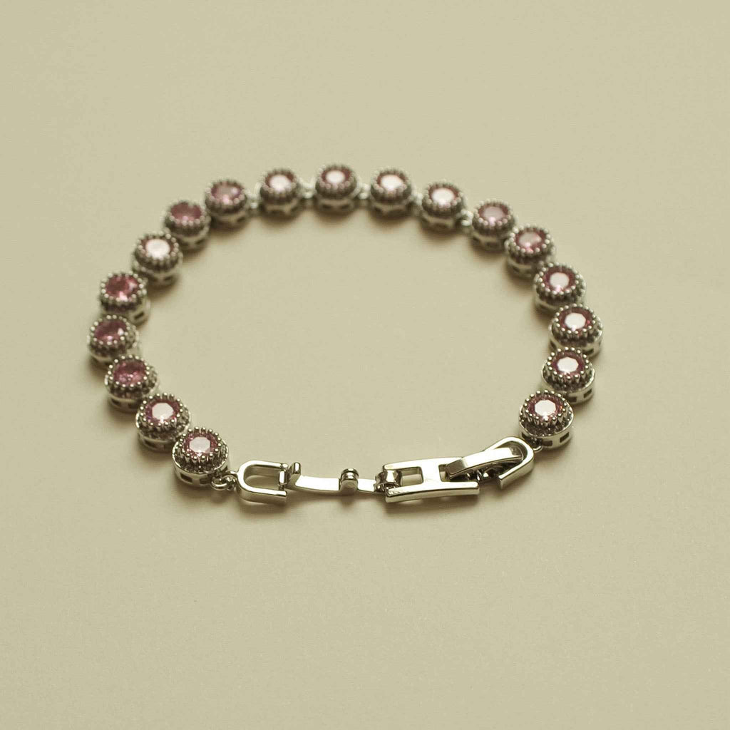 Pink halo CZ tennis bracelet with round pink stones and silver-tone clasp