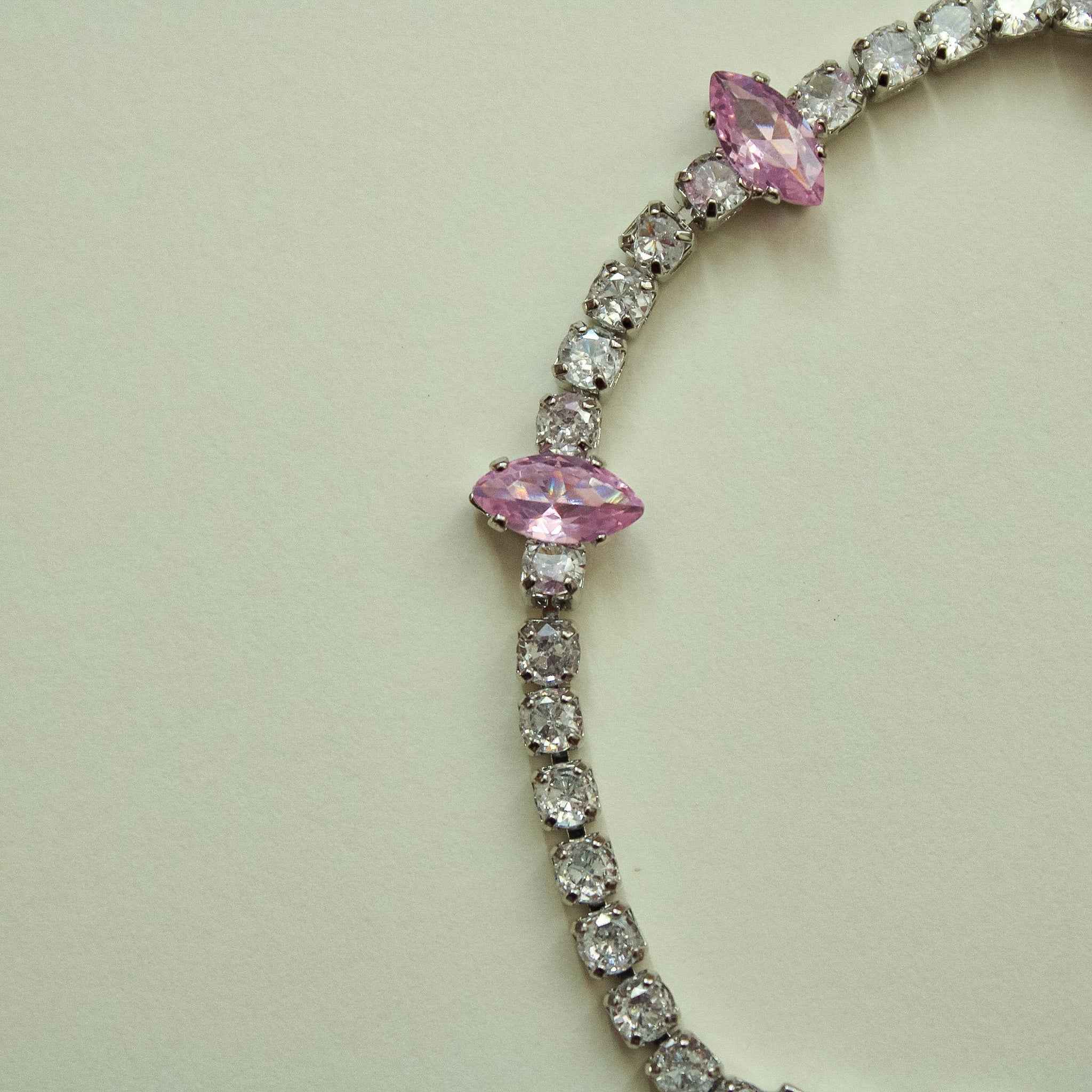 CZ tennis bracelet with marquise pink stones and small clear stones, curved layout