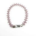 Pink CZ tennis bracelet laid flat with pear-shaped pink stones and a hinged box clasp