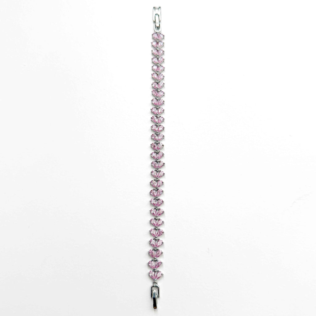 Pink CZ tennis bracelet featuring a row of pear-shaped pink stones with a small clasp end